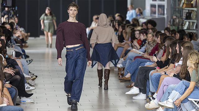 Fashion show runway with two models wearing Alyx Vacca's designs