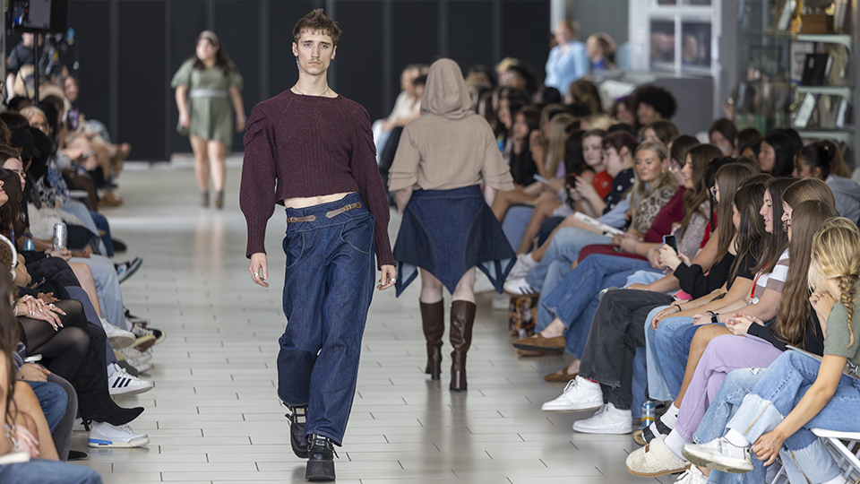 Fashion show runway with two models wearing Alyx Vacca's designs