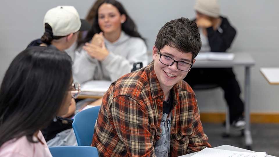 Students cheerfully chatting in a classroom