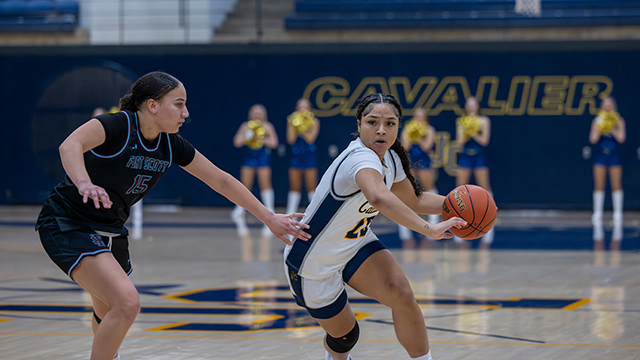 JCCC women's basketball player drives toward the basket for a goal