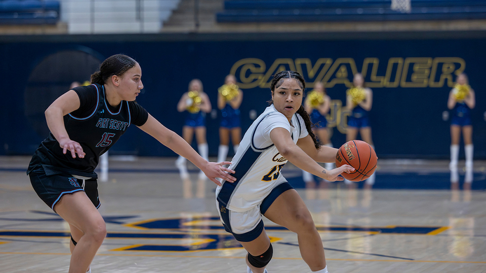 JCCC women's basketball player drives toward the basket for a goal