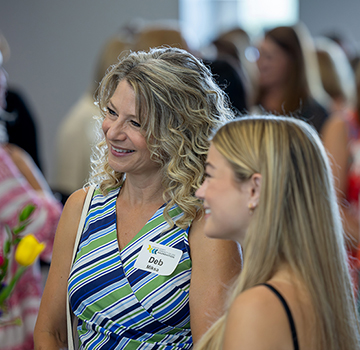women mingling at the 2025 Summer Sips and Scholarships event