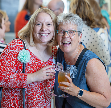 two women smile at the viewer