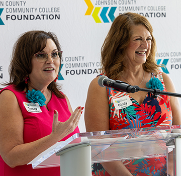 two women introduce a speaker for the summer sips and scholarship event