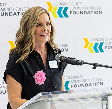 a woman speaking at a podium