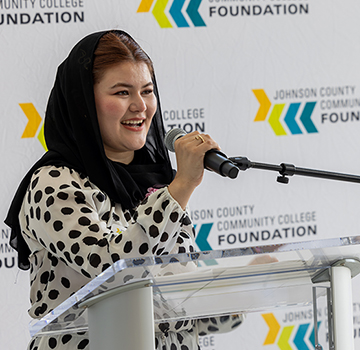 a scholarship recipient speaking at a podium