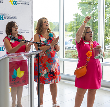 a group of women celebrating scholarship donations