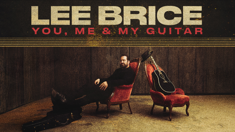 lee brice sitting in a chair next to his guitar and hat