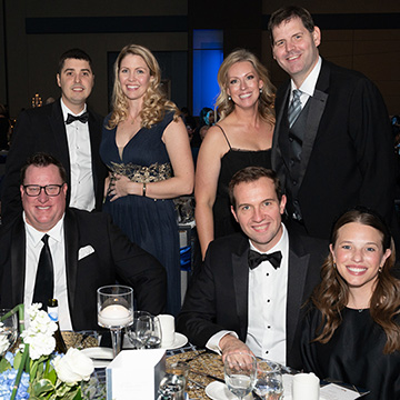 Gala attendees pose for a picture around their table