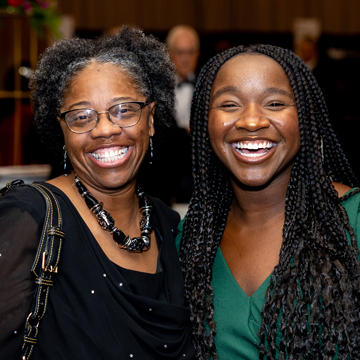 two women with huge smiles at the 2024 Some Enchanted Evening Gala