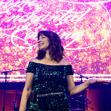 a woman in a glittery dress on the stage