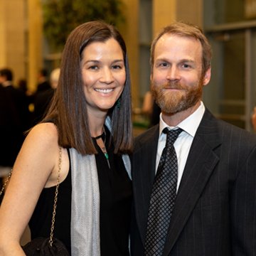 a man and a woman smile at the viewer