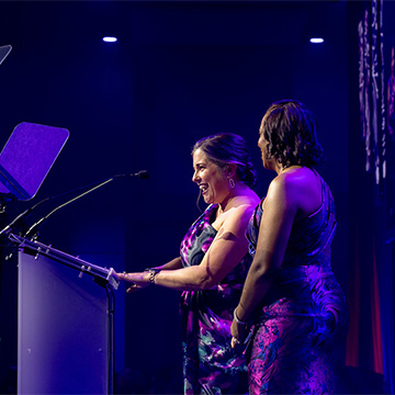 two women speaking on state at the 2025 Some Enchanted Evening Gala
