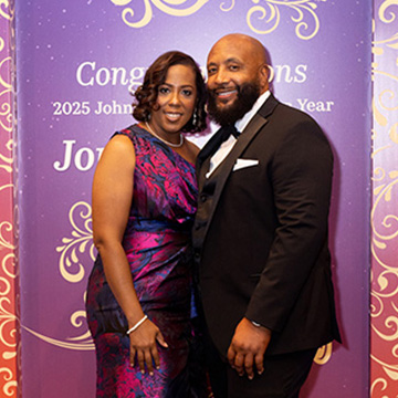 a couple poses for a picture at the 2025 Some Enchanted Evening Gala