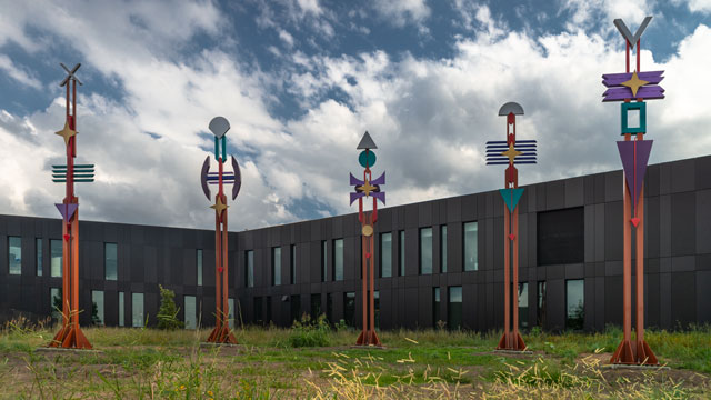 5 spirit totem poles by Doug Coffin