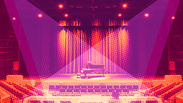 An empty piano on stage in an empty theater.