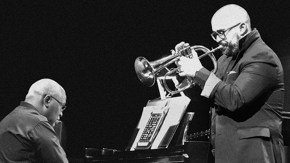 Williams and Ashlock performing together on piano and trumpet