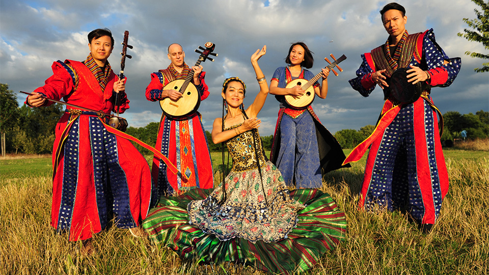 Members of "A Moving Sound" posing in a field