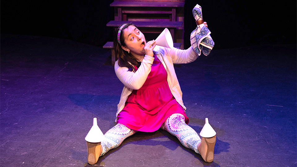 an actress portraying cinderella sitting on the stage