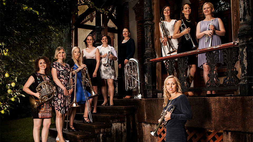 The all female members of tenThing Brass Ensemble pose for a picture while holding their instruments