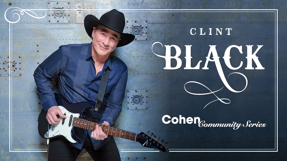 Clint Black smiles at the camera while holding his guitar next to the words Clint Black Cohen Community Series