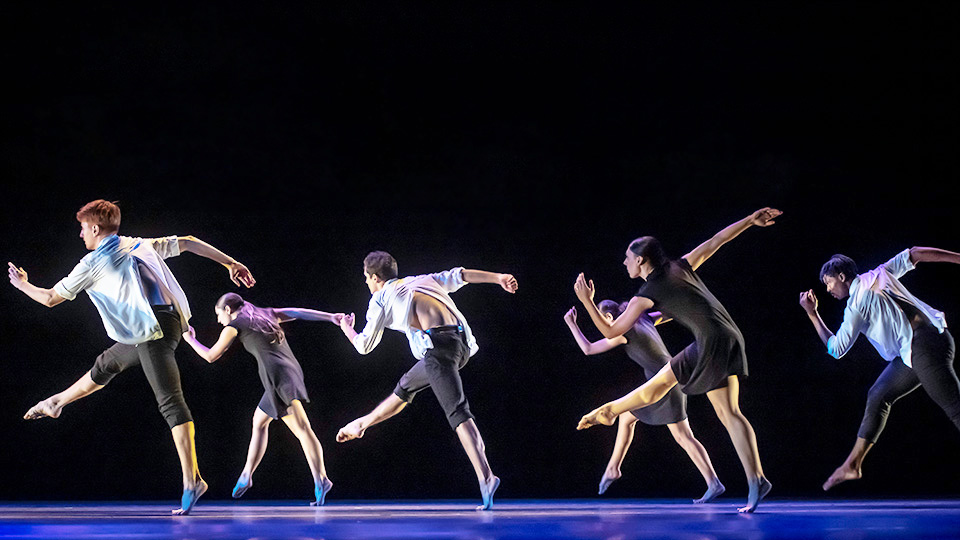 6 members of New Dance Partners dancing on stage in a row 