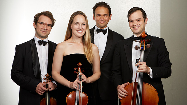 The Opus 76 Quartet standing with instruments