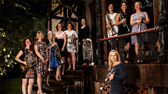 The all female members of tenThing Brass Ensemble pose for a picture while holding their instruments