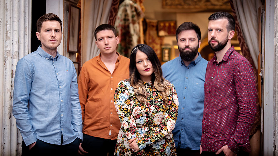 The five members of the band Goitse standing in a row and looking at the camera