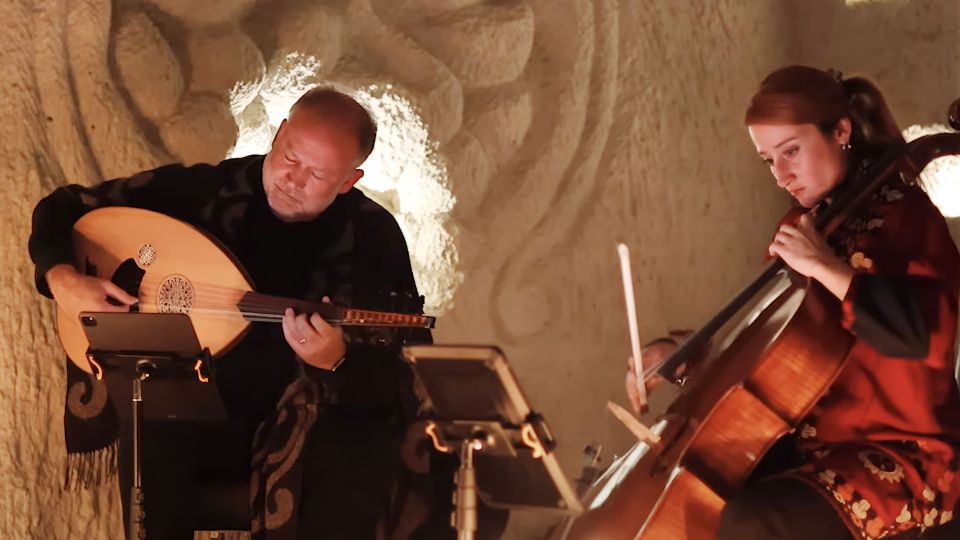 two musicians performing on a softly lit stage