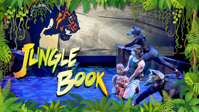 an actor on stage next to an image of a tiger and the words Jungle Book