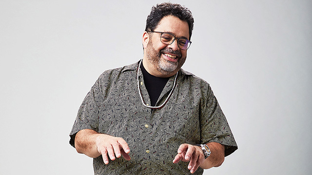 Arturo O'Farrill mimes playing the piano