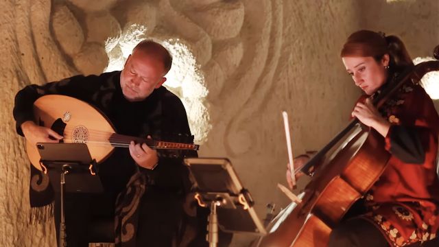 two musicians performing on a softly lit stage
