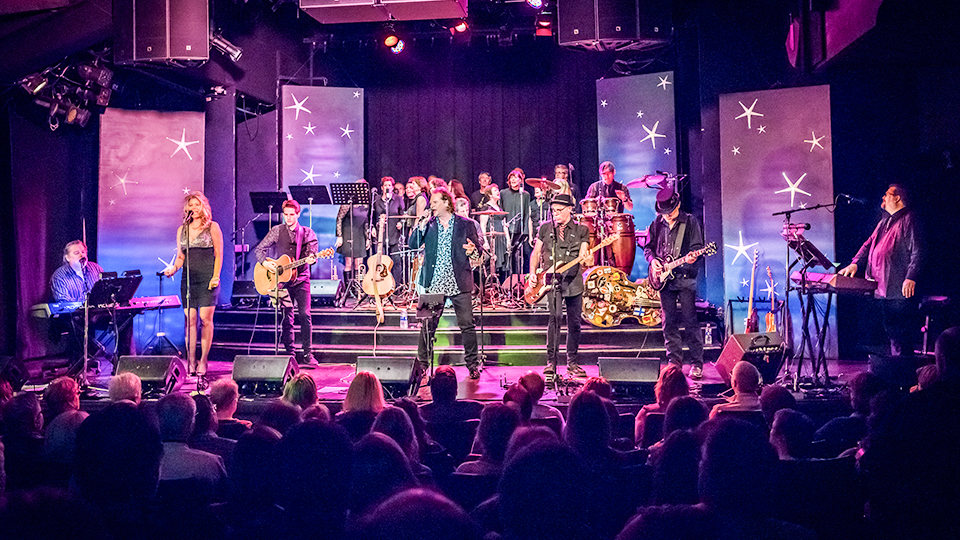 a band performing on stage in front of a crowd