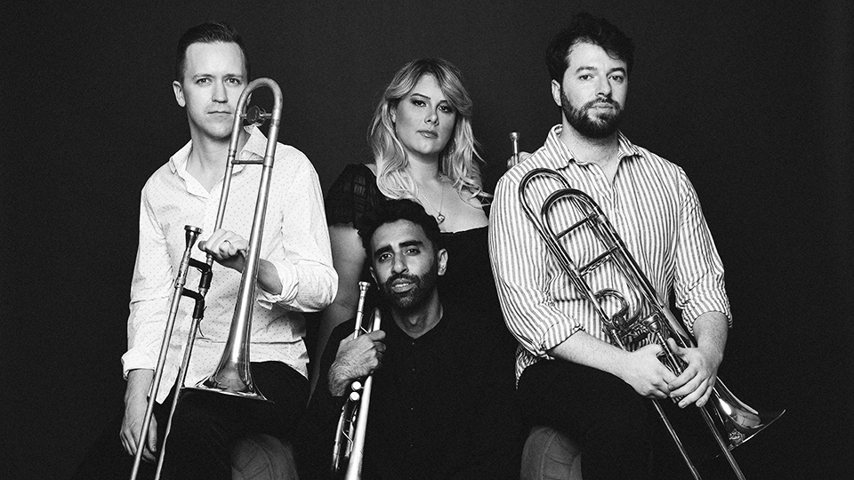 the four members of The Westerlies holding their instruments