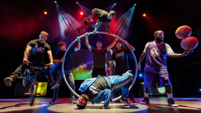 a group of circus performers doing tricks on stage