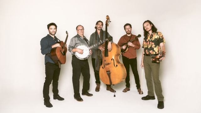 five musicians in a line who are each holding the instrument they play