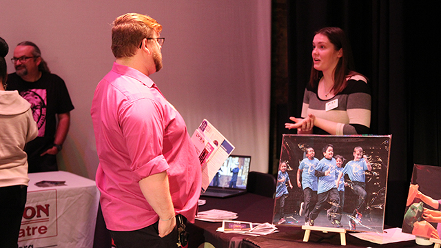 A vendor at the Creative Connection event talks with a local art teacher