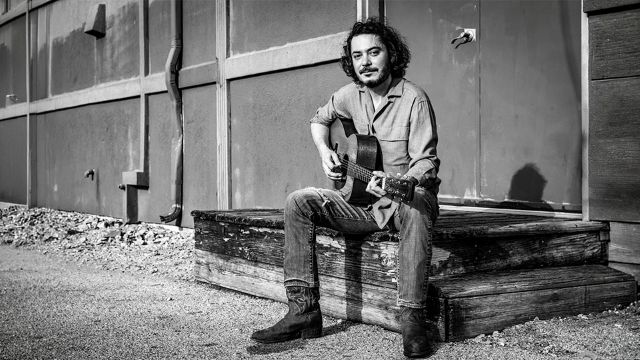 Max Gomez playing the guitar