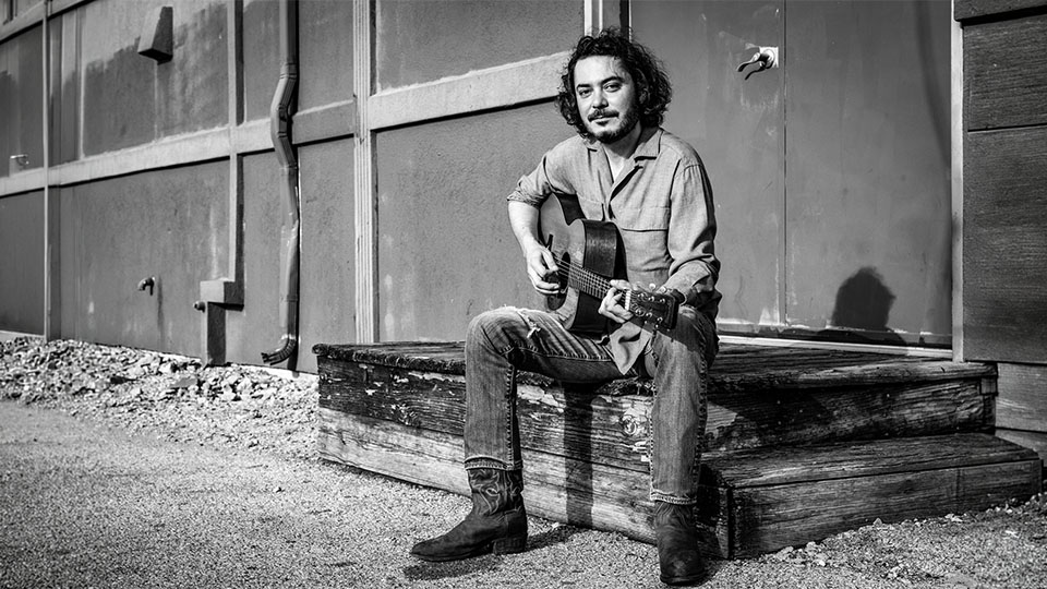 Max Gomez playing the guitar