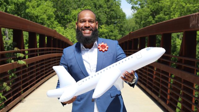 Roy Moye III holding a model airplane