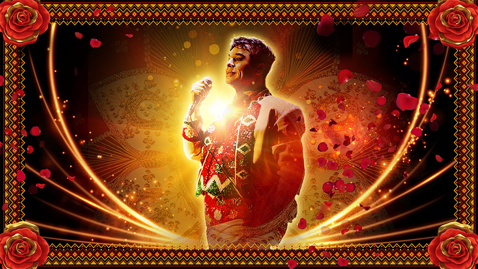 a man standing in front of a glowing background holds a microphone while rose petals fall around him