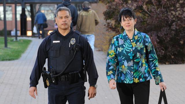 Police officer escorting woman