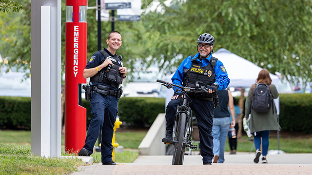 Two police officers, one on a bicycle