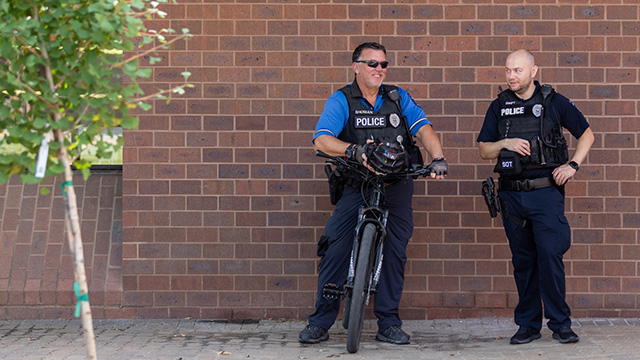 Two police officers, one on a bicycle