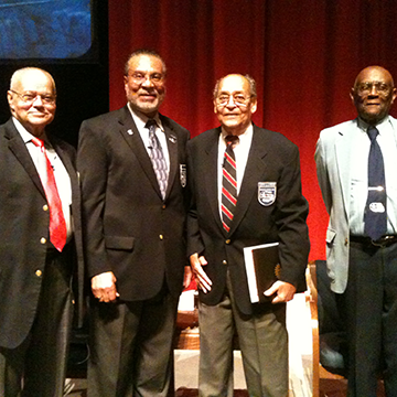 Four Tuskegee Airmen posing on stage