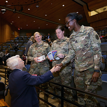 Brig. Gen. Wilma Vaught shaking hands with student veterans in her audience