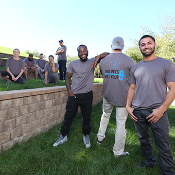 Members of Pave posing on the hill in the courtyard