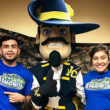 Veteran students posing with JCCC mascot Jean Claude during Camo Day