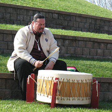 Ed Smith, Osage Nation citizen, playing a native drum in honor of fallen service members